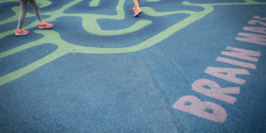 feet running through maze painted on concrete