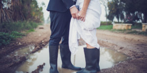 bride and groom in rainboots and puddle